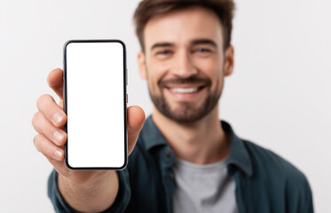 Smiling young man with beard displaying blank smartphone screen