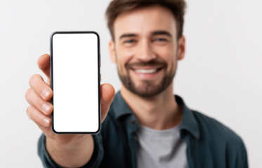 Smiling young man with beard displaying blank smartphone screen