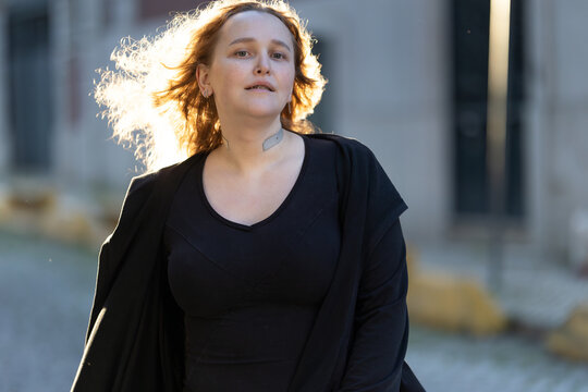 Woman walking outdoors experiencing urban life