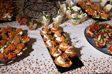 An elegant buffet spread, perfect for events, showcases an array of appetizers and desserts, ready to serve guests.