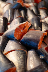 Fresh salmon pieces ready for cooking or sale close-up.