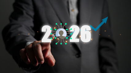 Businessman touching the screen, showing the year 2026 with a user icon and growth arrow. Concept of business trends, technology, human resources, and future planning for success.