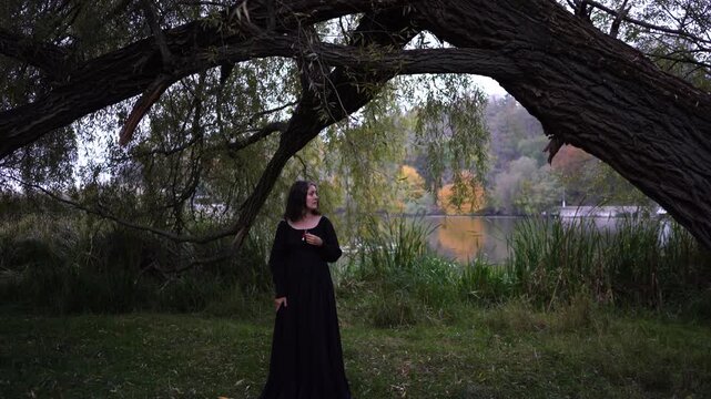      woman in a black long dress for Halloween, Dracula's bride, vampires, modern witch