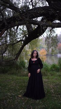      woman in a black long dress for Halloween, Dracula's bride, vampires, modern witch