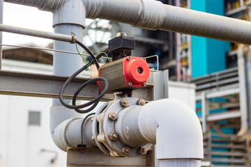 Industrial pipeline shows valve, bolts, motor, and pipes in mechanical background on industrial site