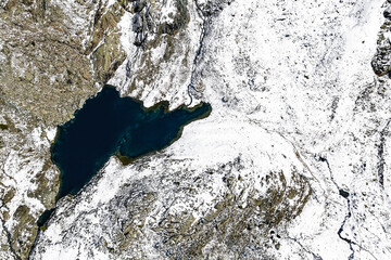 Campagneda lake, Valmalenco, Italy, drone view after snowfall