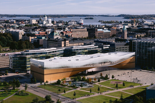Aerial view of the Oodi library's striking modern architecture contrasts with the distant Helsinki Cathedral, a blend of old and new, Helsinki, Uusimaa, Finland.
