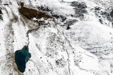 Campagneda lake in Valmalenco, drone view after snowfall