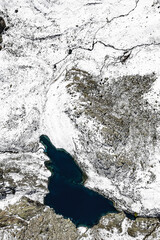 Alpine lake after snowfall, drone view, Valmalenco, Italy landscape