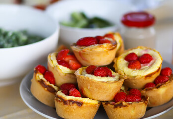 Cupcakes topped with fresh ripe strawberries.