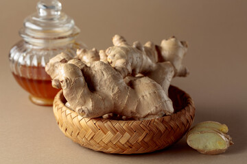 Ginger with honey jar on a beige background.