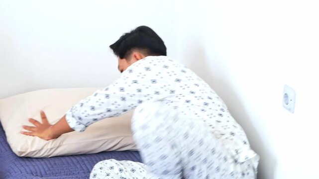 Young Asian Man in sleeping peacefully on floor mattress recovering and resting