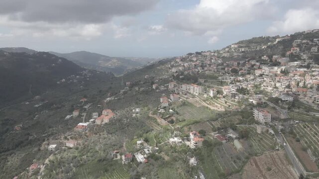 Aerial view of the historic main square in Deir el Qamar, Lebanon, surrounded by traditional stone buildings, houses, and cultural landmarks. 