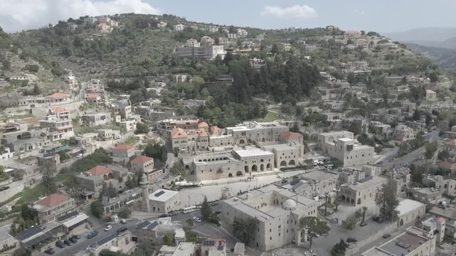 Aerial view of the historic main square in Deir el Qamar, Lebanon, surrounded by traditional stone buildings, houses, and cultural landmarks. 