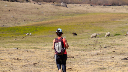 young woman hiking in a mountain area located in Tafi del Valle, Tucuman. in a spring warm morning