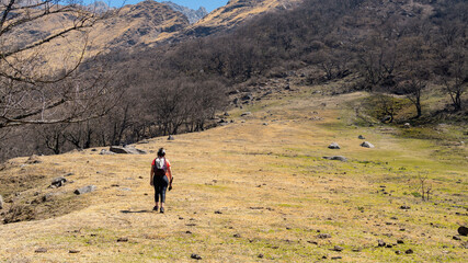 young woman hiking in a mountain area located in Tafi del Valle, Tucuman. in a spring warm morning
