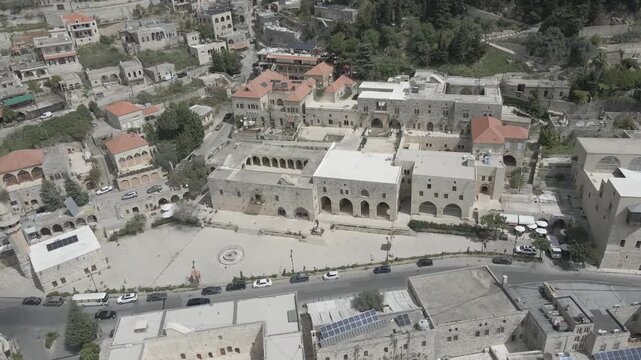 Aerial view of the historic main square in Deir el Qamar, Lebanon, surrounded by traditional stone buildings, houses, and cultural landmarks. 