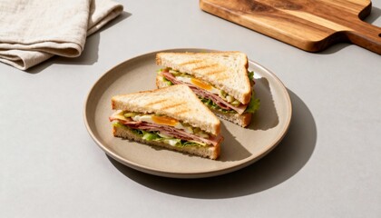 Fresh and tasty sandwiches with layers of meat, cheese, lettuce, and tomato served on artisan bread for a perfect lunch meal. 
