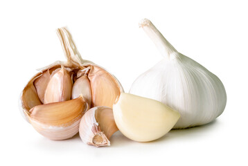 Side view of garlic bulbs with half and cloves in heap isolated on white background with clipping path