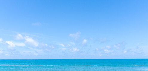 Deep blue sea with blue sky and thin fluffy clouds taken at the sea in Phuket South of Thailand used as blue natural background texture