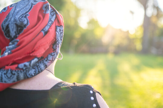 Determined woman with cancer looking towards the future light