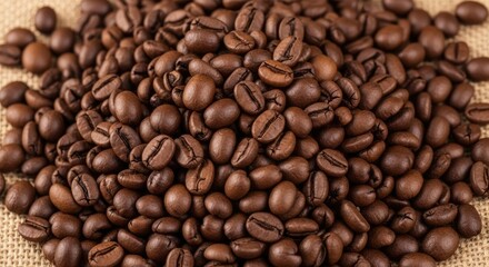 A pile of roasted coffee beans on a burlap sack.