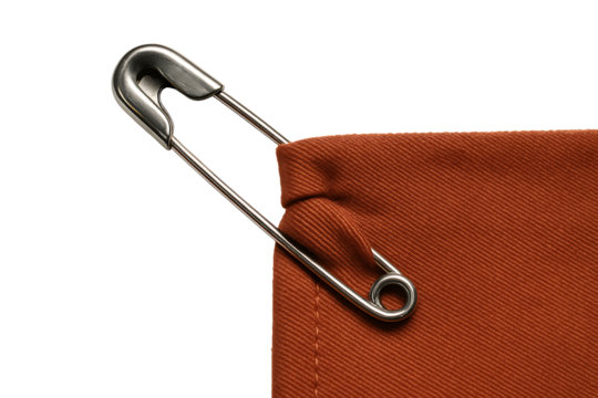 Safety pin on brown fabric isolated on transparent background