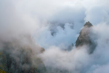 Obraz premium A mountain covered in fog and clouds. Madeira island, Portugal