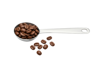 Isolated Measuring spoon full of coffee beans, some scattered near the spoon, no background