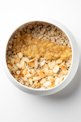 Healthy breakfast bowl with oatmeal, mashed banana, and toasted almonds. Nutritious vegan meal rich in fiber, perfect for clean eating and balanced diet concepts.