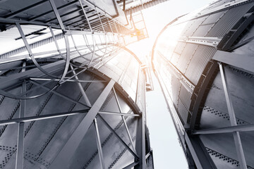 Naklejka premium Industrial agricultural silos for storage and drying of grains, wheat, corn, soy, sunflower with sunlight.