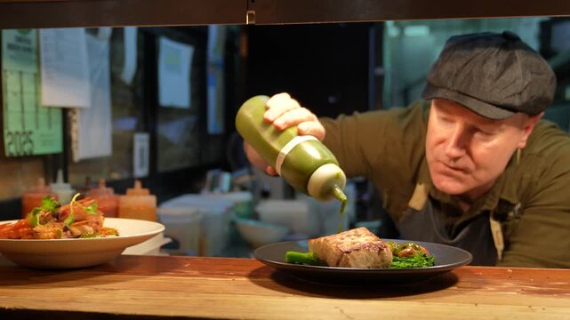 Professional chef garnishing seared tuna steak