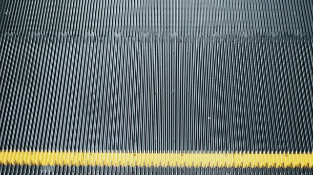 Close up of moving down escalator stairs. Calming rhythm, minimalistic abstract technology texture