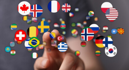 Conceptual image featuring a hand interacting with floating country flags, representing globalization, diplomacy, and world connection. Ideal fo