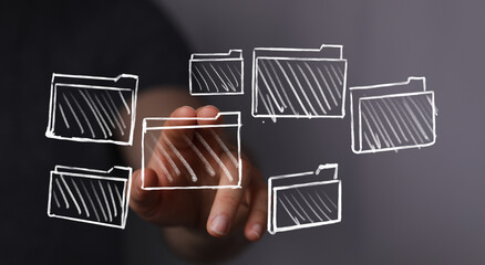 Conceptual image of a hand interacting with digital folder icons, representing data, storage, and the future of technology. Perfect for IT or te