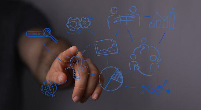 A hand touching a digital interface with business strategy and innovative ideas, representing teamwork, brainstorming and success.