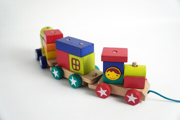 A colorful wooden toy train with blocks of different shapes and numbers, isolated against a white background. This image is perfect for concepts of childhood, learning, games, and vintage toys.

