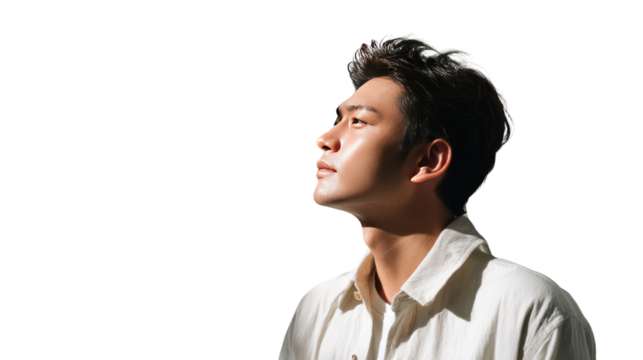 Looking to the future: A serene moment is captured as a person gazes upwards, bathed in the soft glow of natural light, creating a mood of reflection.