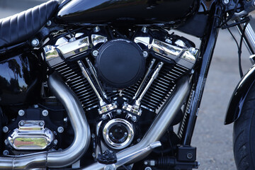 Close-up of a shiny black motorcycle engine with chrome details