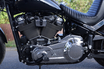 Fototapeta premium Close-up of a shiny black motorcycle engine with chrome details