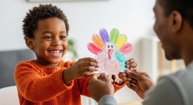 Handmade paper and felt Thanksgiving turkey craft. Black boy shows the toy to his mother.