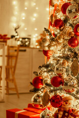a Christmas tree with a New Year decor with red balls and gifts under it, a New Year's festive atmosphere at home