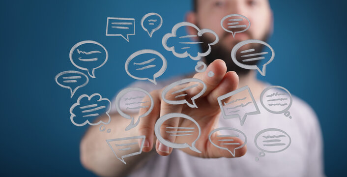 Man interacting with floating speech bubbles, symbolizing digital connection and communication. Good visual for social media, tech and modern in