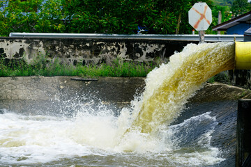 Water Discharge Flowing from Pipe into River with Turbulent Surface