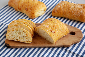 Homemade Cheese Ciabatta Bread on a Wooden Board, side view.