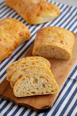 Homemade Cheese Ciabatta Bread on a Wooden Board, side view.