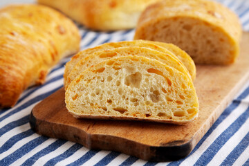Homemade Cheese Ciabatta Bread on a Wooden Board, side view. Close-up.