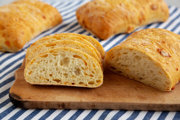 Homemade Cheese Ciabatta Bread on a Wooden Board, side view. Close-up.