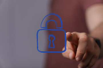 A hand interacts with a glowing blue digital padlock, symbolizing robust cybersecurity, data...
