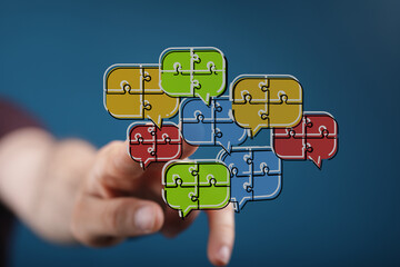 A hand pointing to multiple puzzle piece speech bubble icons, representing concepts like communication, teamwork, ideas, and digital interaction